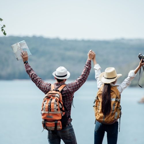 Couple family traveling together,Tourist couple Backpack along mountains and coast, freedom and active lifestyle concept